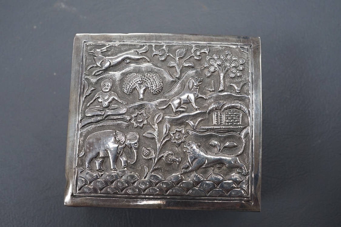 An Indian small square white metal cigarette box, embossed with animals and figures, width 78mm, 4.4oz.